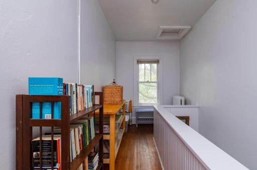 Back stairs and storage offer access to all three units and the basement.