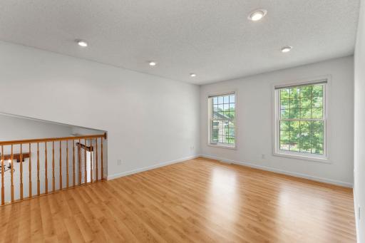 Upper level living room with plenty of overhead lighting