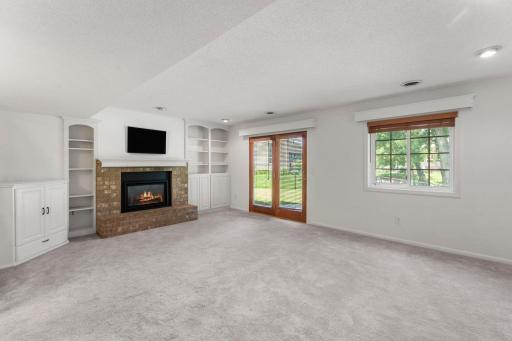 Cozy fireplace surrounded by built-in cabinets