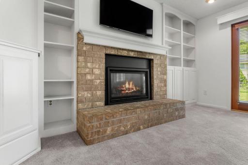 Cozy gas fireplace surrounded by built-ins is the centerpiece of the Lower level family room