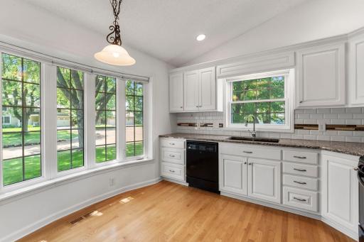 Beautiful and bright kitchen with plenty of windows and space for a breakfast nook