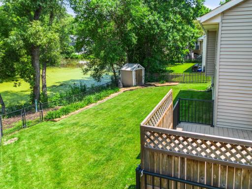 Peaceful setting in the backyard with a pond and mature trees