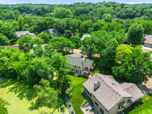 A pond and mature trees add to private feel of the backyard
