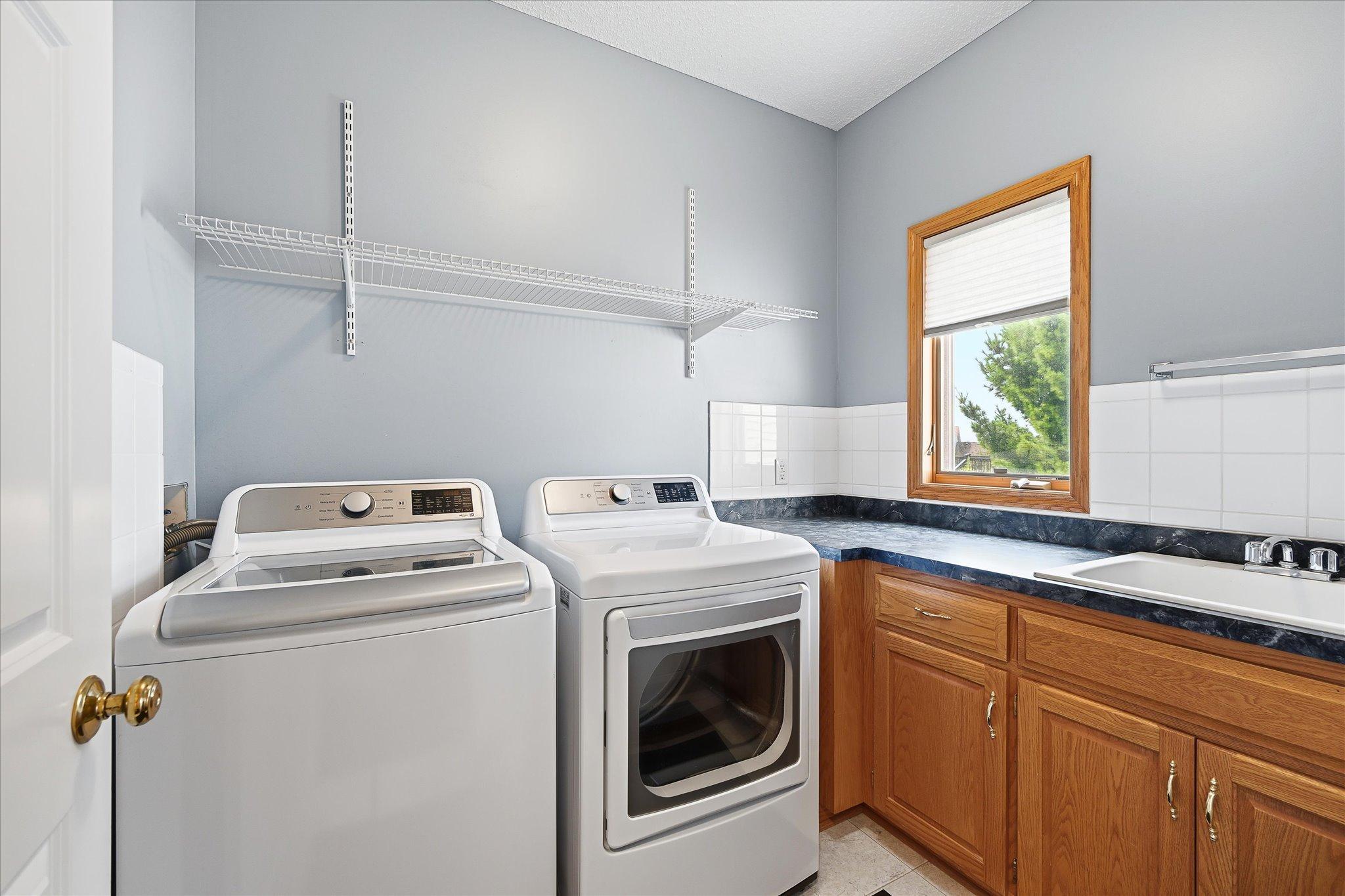 Dedicated laundry room with additional storage.