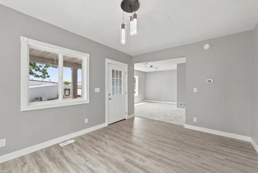 Large dining room with a bright front window