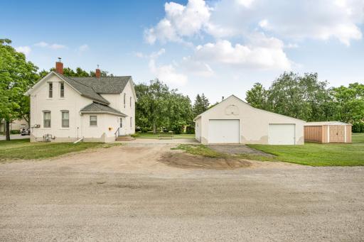 Concrete patio between the house and garage is the perfect space to enjoy the beautiful yard