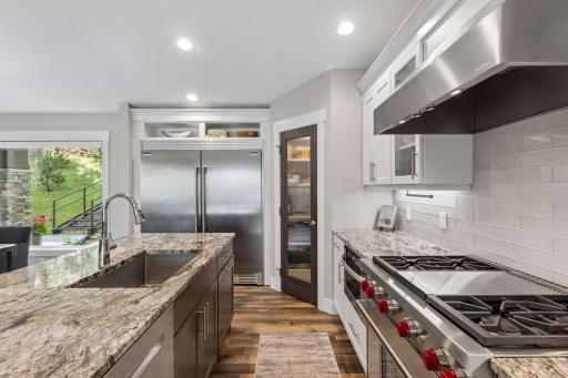 Wolf Range, granite countertops, beautiful backsplash, double-door stainless steel refrigerator and more!