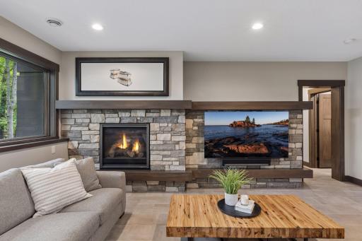 Lower level family room, lots of light, views towards river, gas fireplace and fantastic wet bar area, great for entertaining.