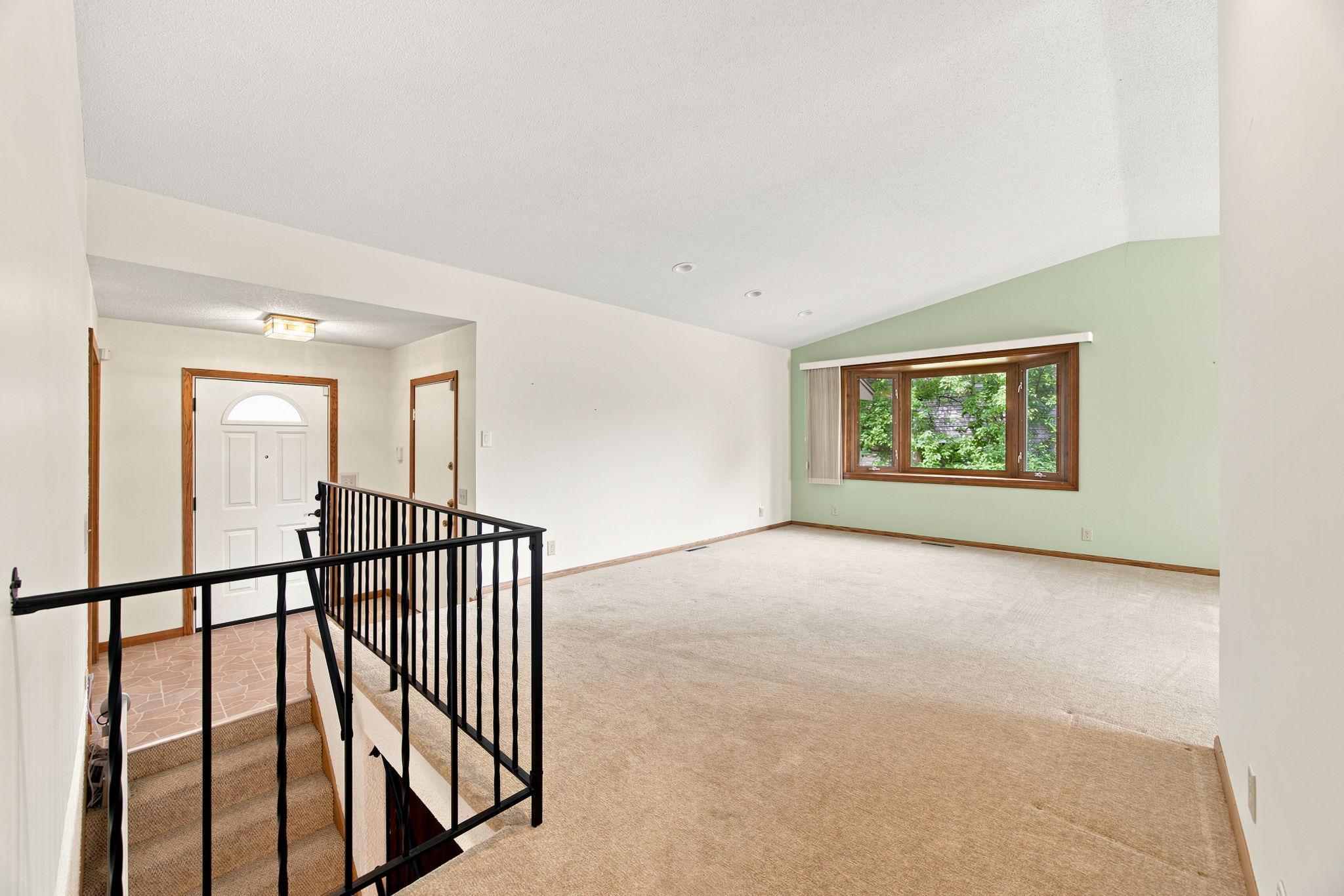 Entry and vaulted living room.