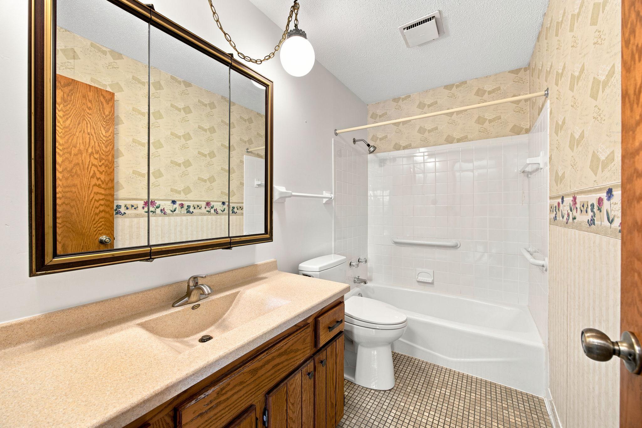Upper level bath with tile floor.