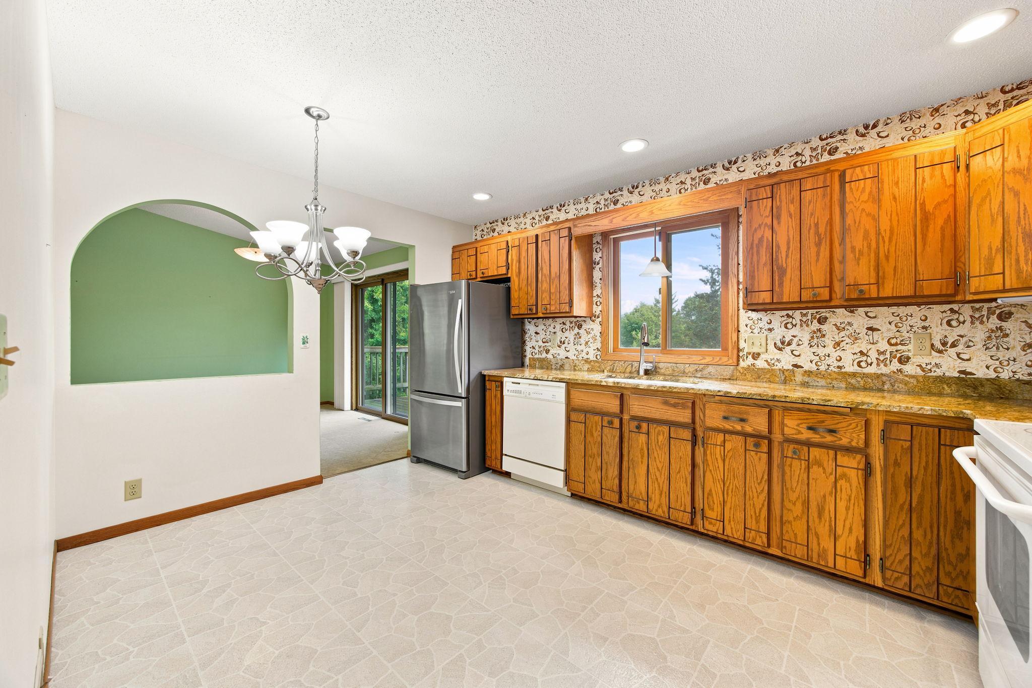 Informal eating area space in kitchen with cute roundtop opening.