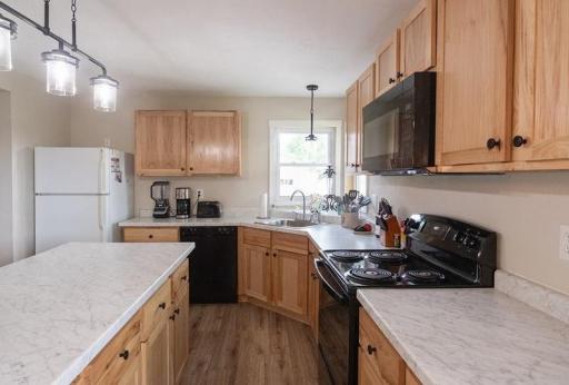 Updated countertops, cabinets, appliances, light fixtures, and flooring.