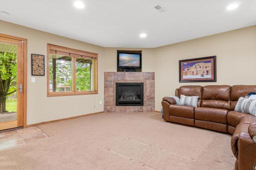 Cozy lower-level gas fireplace creates the perfect gathering space.