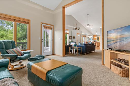 View from the four-season porch looking towards the living room, dining room and kitchen beyond. Enjoy time on your deck with your favorite beverage at the end of the day.