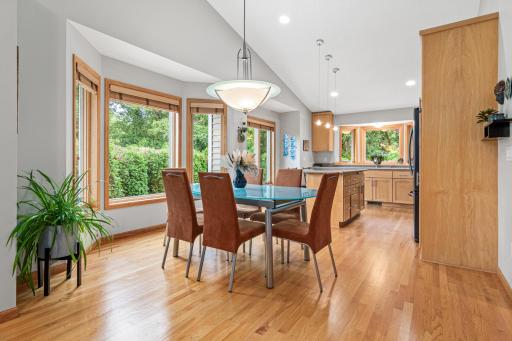 Dining room flows to the expansive kitchen with walls of window bringing in the natural light.