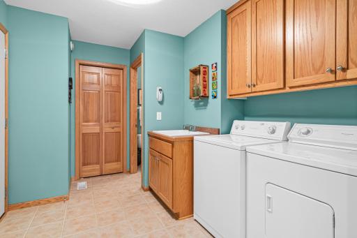 Main floor laundry and mudroom- perfect place to drop groceries. Provides great access to the 3/4 bathroom and the dining room the other way.