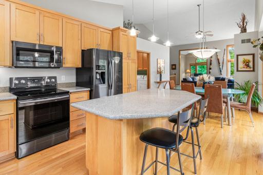 Kitchen opens seamlessly to dining and living areas.
