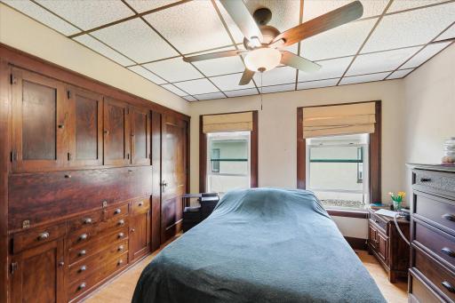 Main level bedroom with custom built-in drawers and cabinets.