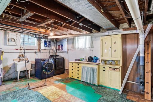 Laundry area with folding table and storage.