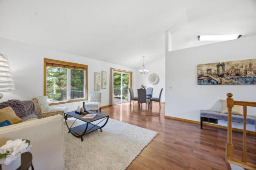 The mature pine trees create a serene natural backdrop! Easy access to the dining room and maintenance free deck from the living room create a great space for hosting gatherings.