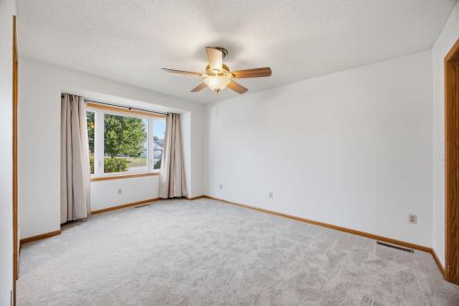Primary Bedroom with a brand-new window and carpet!