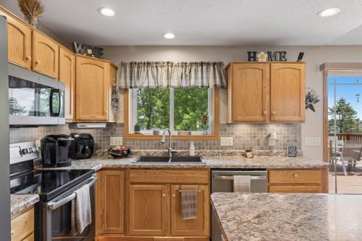 Warm wood cabinetry paired with beautiful countertops creates a timeless kitchen.