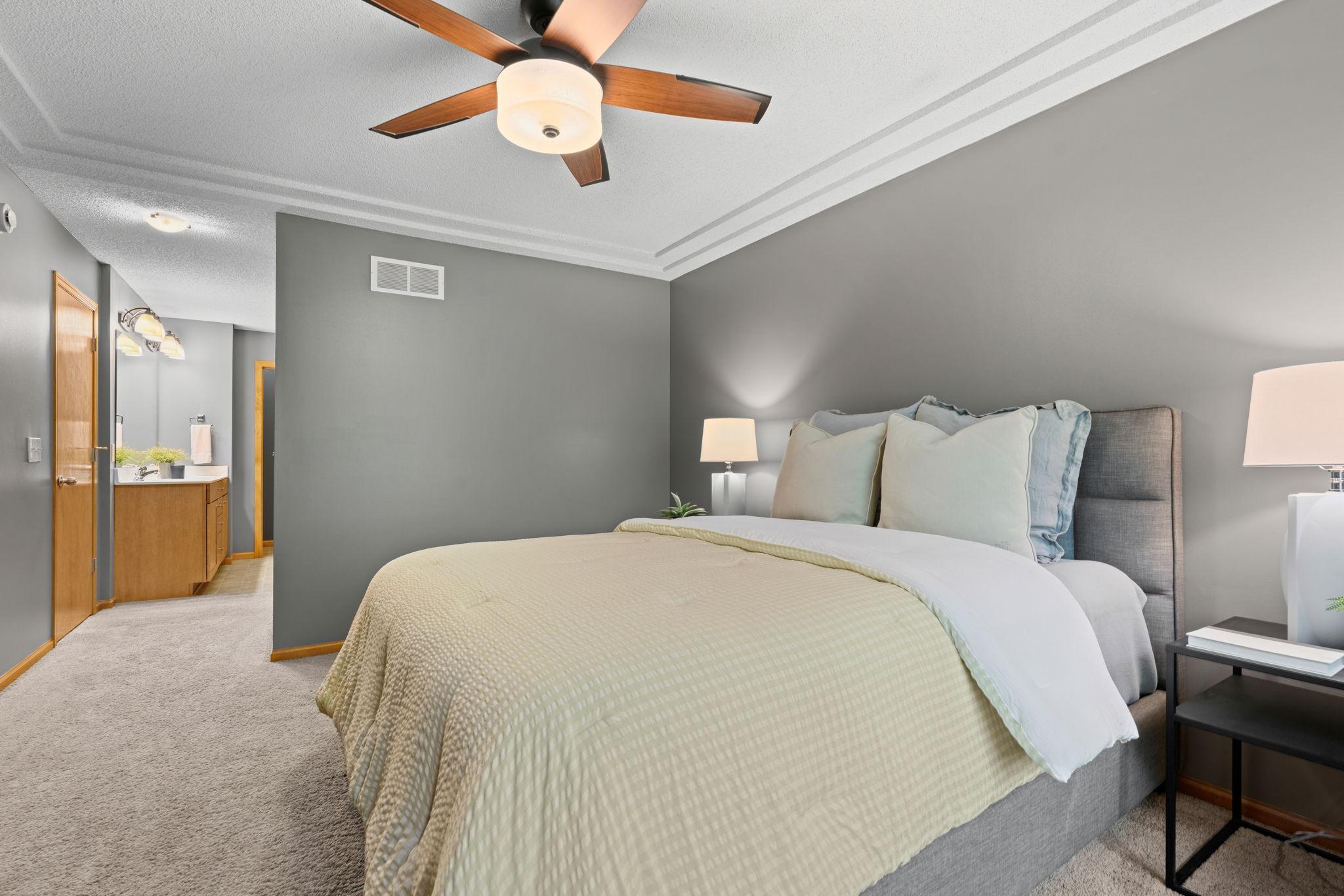 primary bedroom with glance of ensuite in the back
