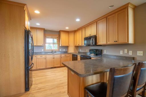 Generous sized kitchen with to the ceiling cabinets for ample storage