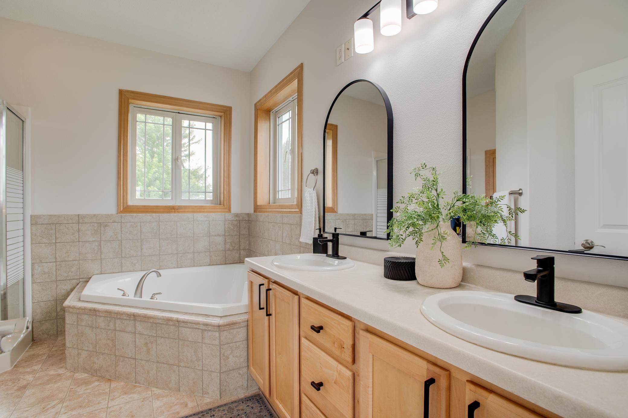 Jetted tub, double sinks, updated lighting, mirrors, faucets and hardware
