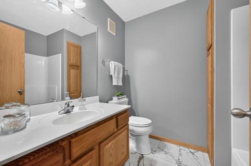 Upper level full bath w/updated floor, linen closet and spacious vanity. Just steps away from the 2nd bedroom.