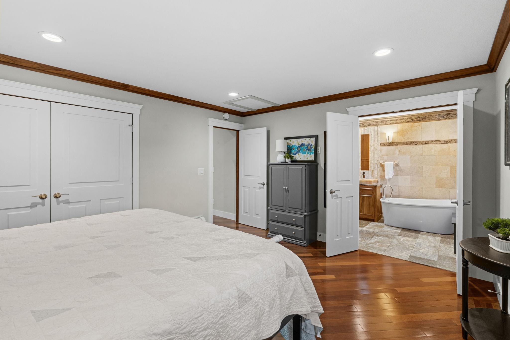 View of the primary suite - a peek into the private primary bathroom!