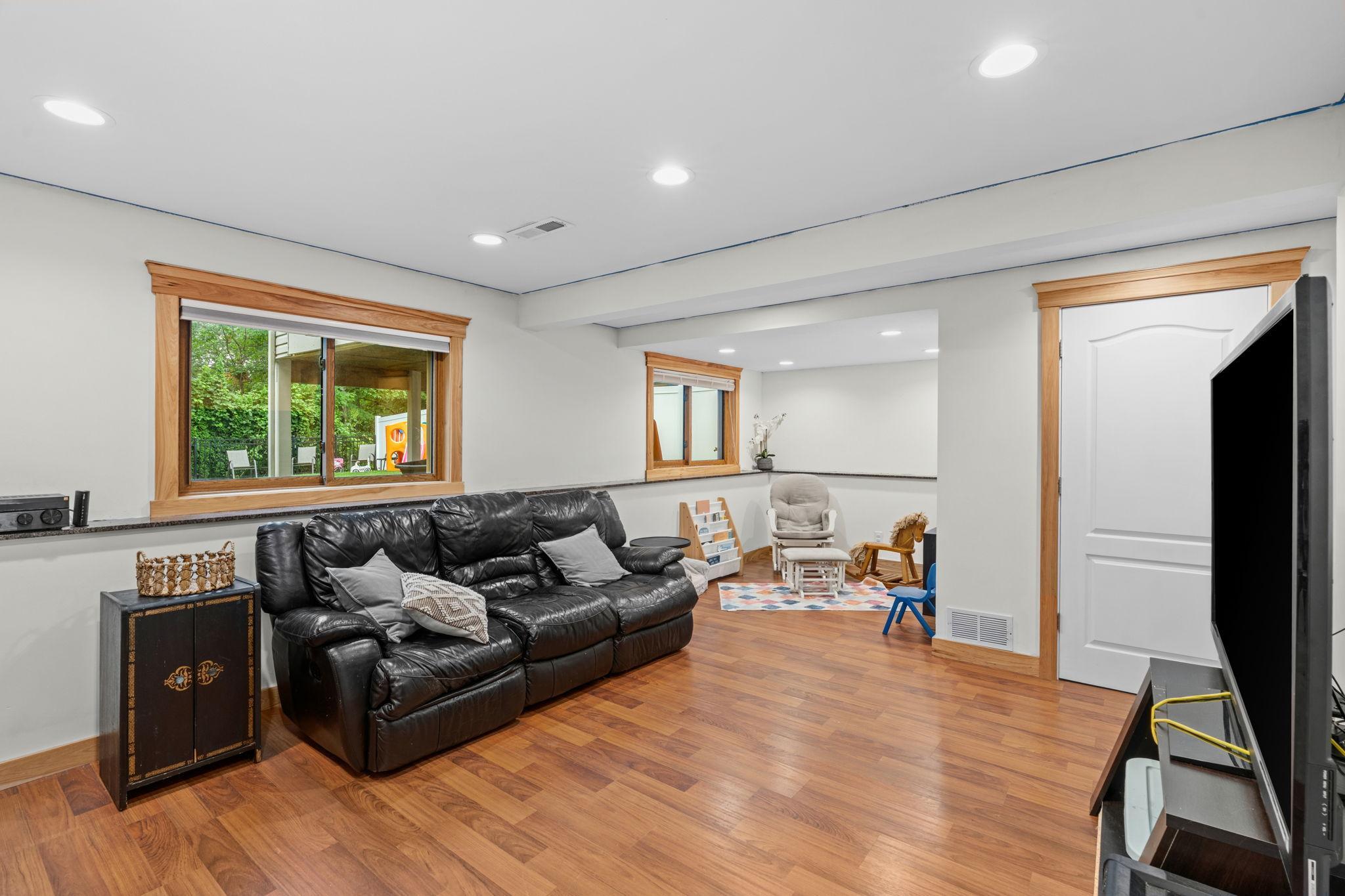 Spacious lower level family room with lookout windows and a perfect nook for a play area, desk space, or reading corner.