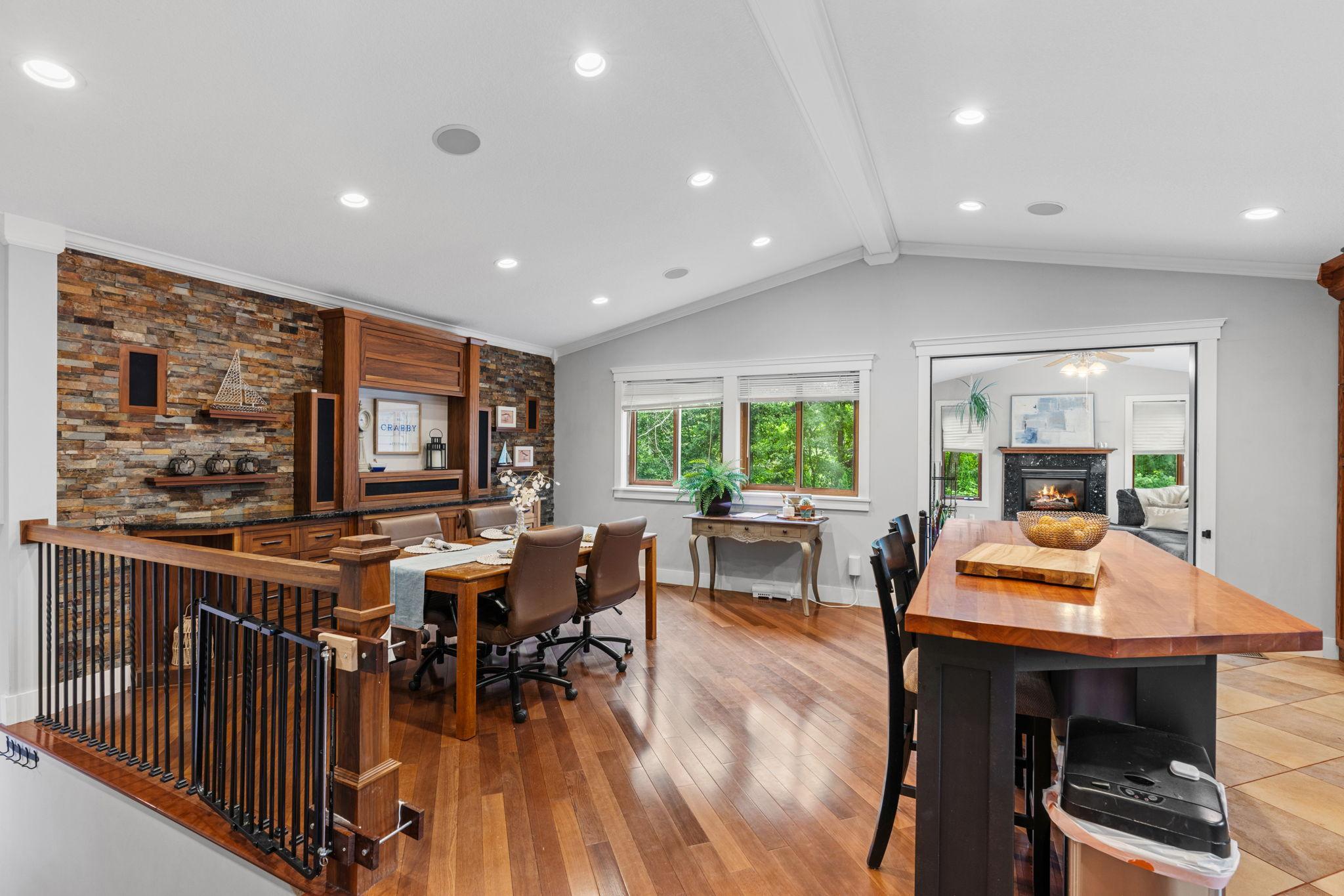 The open and bright main level! Large center island and spacious dining area, vaulted ceilings and wood floors.