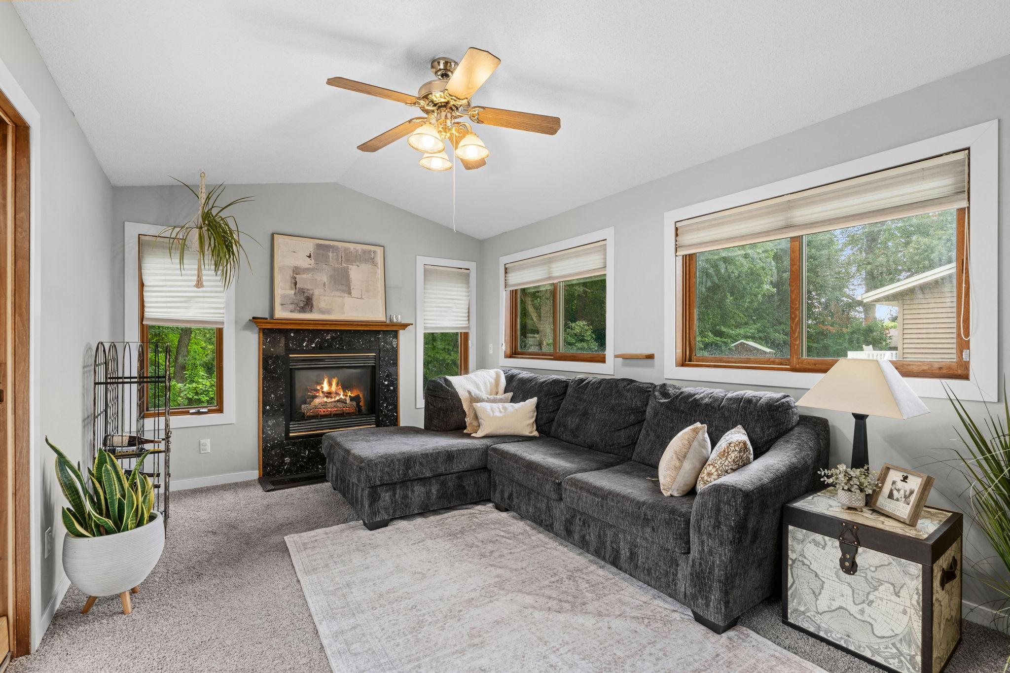 The main level family room/sun room! Enjoy a gas fireplace in the cooler months and views of your private and wooded backyard.
