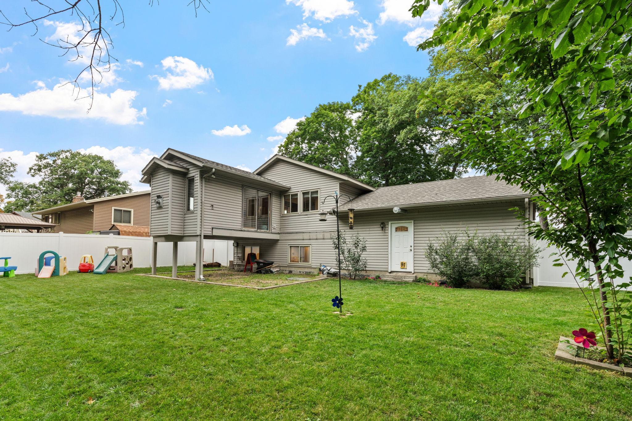 The spacious backyard! Flat green space for pets or kids. New fence in 2024