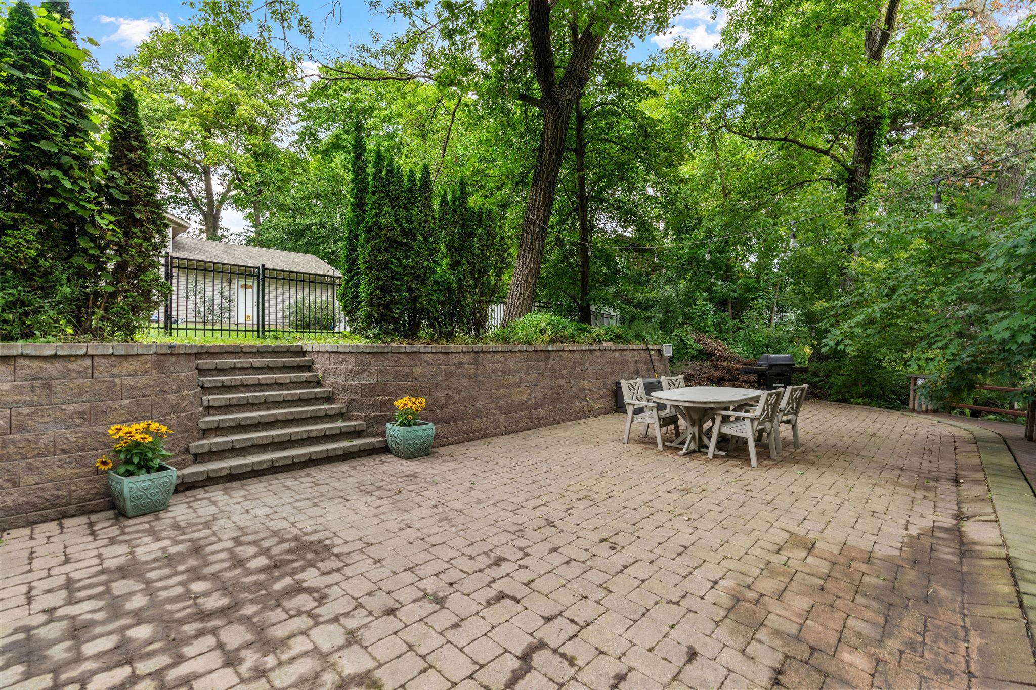 BONUS! This cobblestone patio terrace is an entertainers dream! Host summer parties or fall bonfires on your terrace overlooking the wooded area.