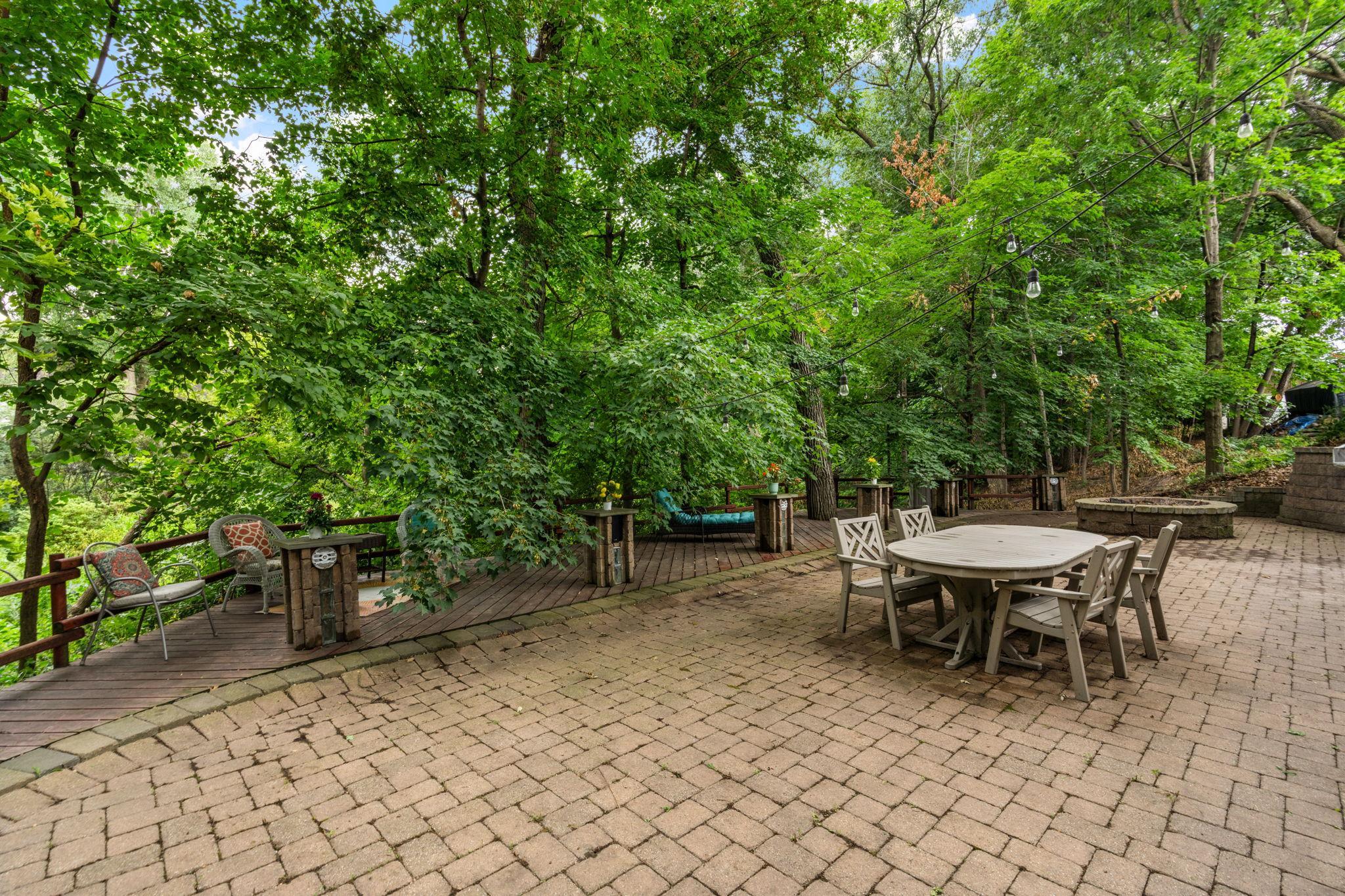 View of the Cobblestone patio and deck with serene nature views!