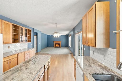 Kitchen is connected to eat in area and open to living room with gas fireplace