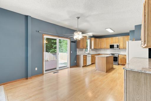 Sliding doors off of kitchen open to maintenance free deck and fully fenced back yard