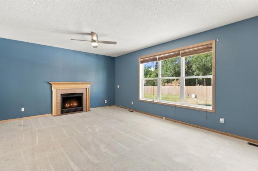 Living room with gas fireplace, and views of the private backyard