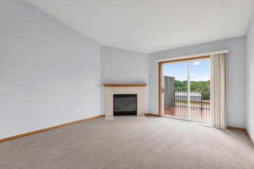 Living Room with Tile Gas Fireplace and Patio Door out to the Back Deck