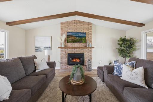 Family room with a gas fireplace and vaulted ceiling