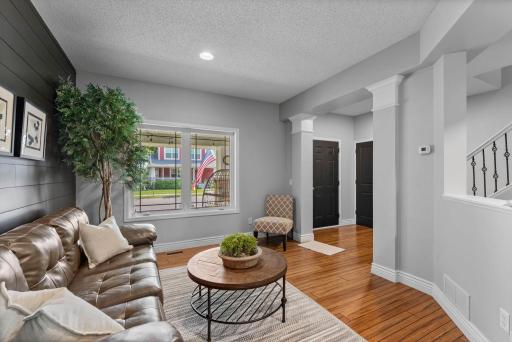 Just beyond, a versatile sitting room offers the perfect space for casual conversation, a formal dining room, or a flexible area to suit your needs.