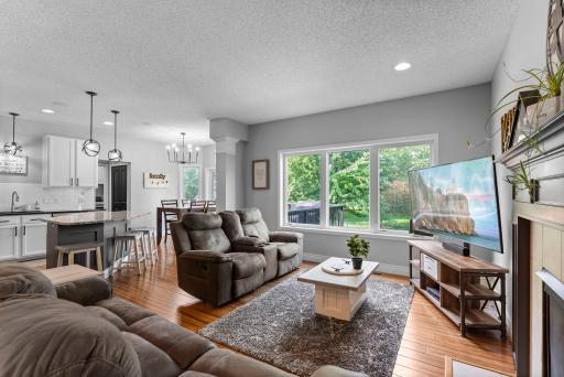 The connected main level is designed for both comfortable everyday living and effortless entertaining, anchored by hand-scraped bamboo flooring that flows throughout.