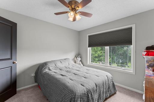 The two additional upper-level bedrooms each feature ceiling fans, walk-in closets, and comfortable carpeting.