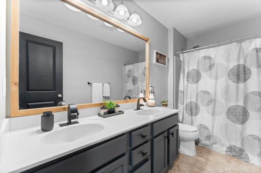 A shared full bathroom with double vanity and hall closet storage completes the upper level.