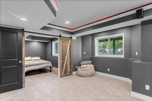 Sliding barn doors lead into the fifth bedroom, creating a perfect private guest retreat.