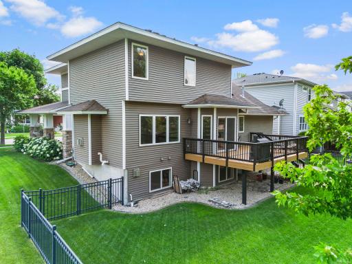 The attached three-car tandem garage includes a workshop space complete with shelving, a ceiling fan, and its own dedicated furnace, making it a comfortable workspace year-round.