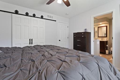 A standout feature is the custom handmade sliding barn doors leading into the closet, adding warmth and character while maximizing usable space. Inside the closet, an upgraded organization system provides excellent storage.