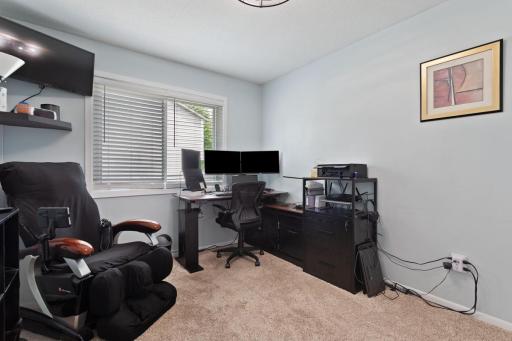 Two bedrooms up and two bedrooms down. This bedroom, currently used as an office, has an updated ceiling fan/light fixture with a remote. The entire home has updated six panel doors throughout!